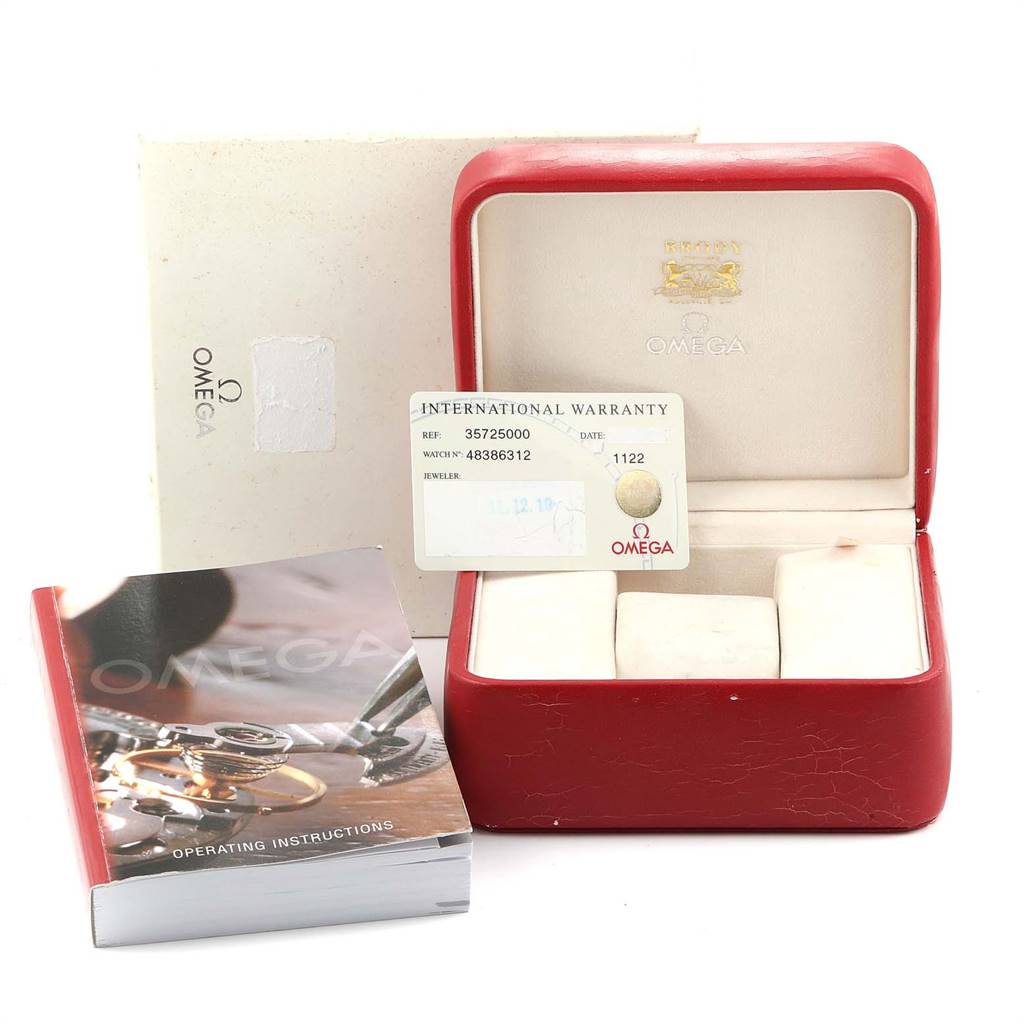 The image shows a red Omega Speedmaster 3572.50.00 Men
s Stainless Steel Black Dial 3572.50.00 Men
s Stainless Steel Black Dial watch box, an international warranty card, an operating instructions booklet.