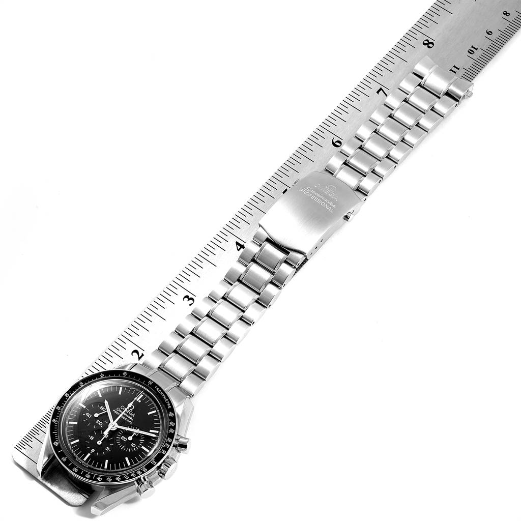 The Omega Speedmaster 3570.50.00 Men
s Stainless Steel Black Dial 3570.50.00 Men
s Stainless Steel Black Dial watch is shown flat with a ruler, displaying its face, bracelet, and clasp.