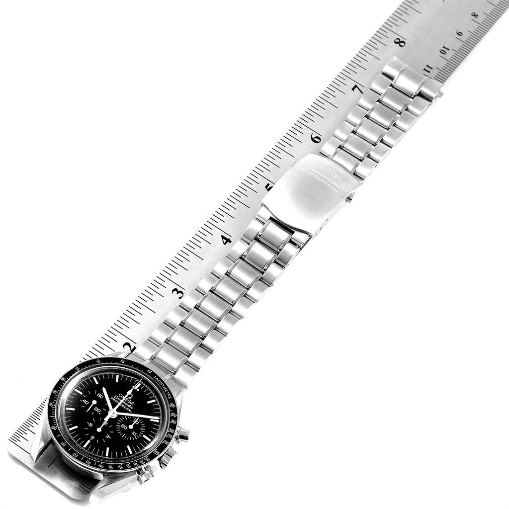 The image shows an Omega Speedmaster 3572.50.00 Men
s Stainless Steel Black Dial 3572.50.00 Men
s Stainless Steel Black Dial watch laid flat, exposing the face, bracelet, and clasp next to a ruler for scale.