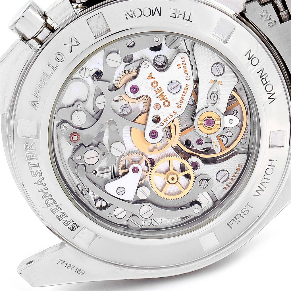 The image shows the back view of an Omega Speedmaster 3572.50.00 Men
s Stainless Steel Black Dial 3572.50.00 Men
s Stainless Steel Black Dial watch, highlighting its mechanical movement and detailed engravings.