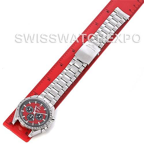 The Omega Speedmaster 3506.61 Stainless Steel Red Dial 3506.61 Stainless Steel Red Dial watch is shown from above, displaying its face and metal bracelet measured against a red ruler.