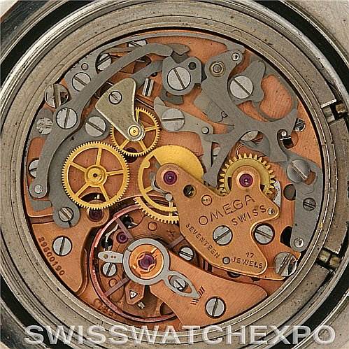 The image shows a detailed view of the intricate inner mechanism of an Omega Speedmaster Men's Stainless Steel Black Dial Men's Stainless Steel Black Dial watch, highlighting its gears and components.