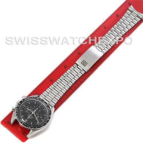 The image shows an Omega Speedmaster Men's Stainless Steel Black Dial Men's Stainless Steel Black Dial watch laid flat, face-up against a red ruler, displaying its entire bracelet and clasp.