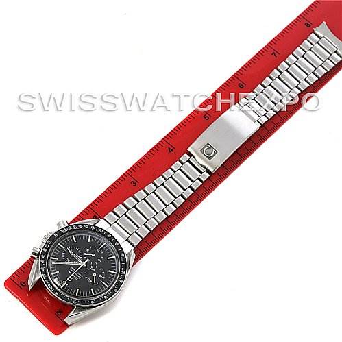 The image shows an Omega Speedmaster Men's Stainless Steel Black Dial Men's Stainless Steel Black Dial watch laid flat, displaying the face, bezel, and full metal bracelet alongside a red ruler.