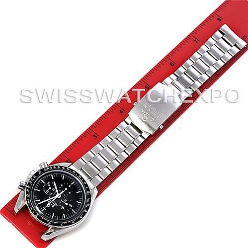 The image shows an Omega Speedmaster 3570.50 Men
s Stainless Steel Black Dial 3570.50 Men
s Stainless Steel Black Dial in a flat position, highlighting the watch face, bracelet, and clasp next to a red ruler.