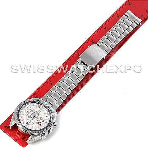 The image shows an Omega Speedmaster 3581.30.00 Men's Stainless Steel White Dial 3581.30.00 Men's Stainless Steel White Dial watch laid flat on a red ruler, displaying the watch face and full metal bracelet from a top-down angle.