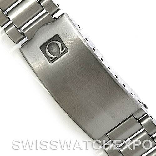 The image shows the clasp and part of the metal bracelet of the Omega Speedmaster Men
s Stainless Steel Black Dial Men
s Stainless Steel Black Dial watch from a top-down angle.