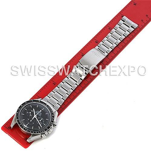 The Omega Speedmaster 3570.50 Men's Stainless Steel Black Dial 3570.50 Men's Stainless Steel Black Dial watch is shown lying flat against a red ruler, providing a full view of its face and metal bracelet.