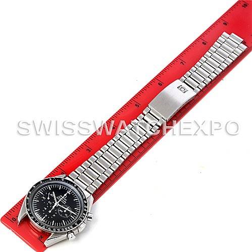 The image shows an Omega Speedmaster 145022 Men
s Stainless Steel Black Dial 145022 Men
s Stainless Steel Black Dial watch laid flat alongside a red ruler, displaying its face, stainless steel bracelet, and clasp.