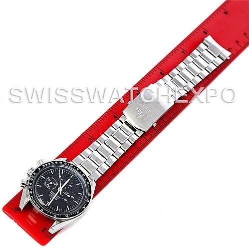 This image shows an Omega Speedmaster 3570.50 Men
s Stainless Steel Black Dial 3570.50 Men
s Stainless Steel Black Dial watch laid flat, highlighting its face, bezel, and stainless steel bracelet on a red ruler.