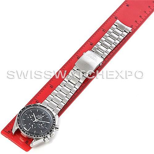 The image shows an Omega Speedmaster 3572.50.00 Men
s Stainless Steel Black Dial 3572.50.00 Men
s Stainless Steel Black Dial watch laid flat on a red ruler, displaying its face and full metal bracelet.
