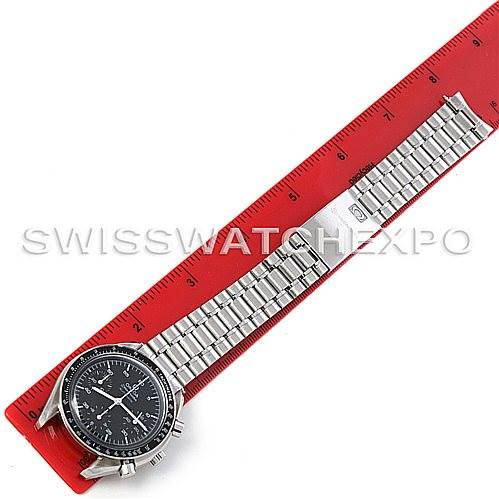 The Omega Speedmaster 3510.50.00 Men
s Stainless Steel Black Dial 3510.50.00 Men
s Stainless Steel Black Dial watch is shown laid flat against a red ruler, displaying the entire watch face and metal bracelet.