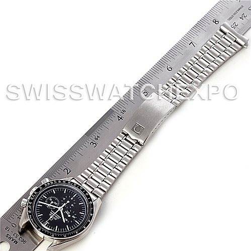 The image shows an Omega Speedmaster 3570.50.00 Men
s Stainless Steel Black Dial 3570.50.00 Men
s Stainless Steel Black Dial watch laid flat from an aerial view, alongside a ruler for measurement.