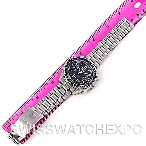 The Omega Speedmaster 3510.50.00 Men
s Stainless Steel Black Dial 3510.50.00 Men
s Stainless Steel Black Dial watch is displayed from a top-down angle, including its full bracelet and clasp, next to a pink ruler for scale.