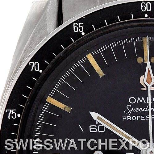 The image shows a close-up of the Omega Speedmaster 145.012 Men's Stainless Steel Black Dial 145.012 Men's Stainless Steel Black Dial watch, focusing on the bezel, dial, and part of the watch case.