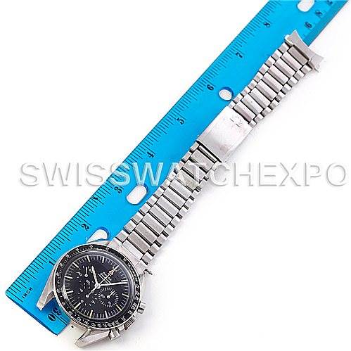 The image shows an Omega Speedmaster 145.012 Men's Stainless Steel Black Dial 145.012 Men's Stainless Steel Black Dial watch laid flat next to a blue ruler, displaying its face and metal bracelet.