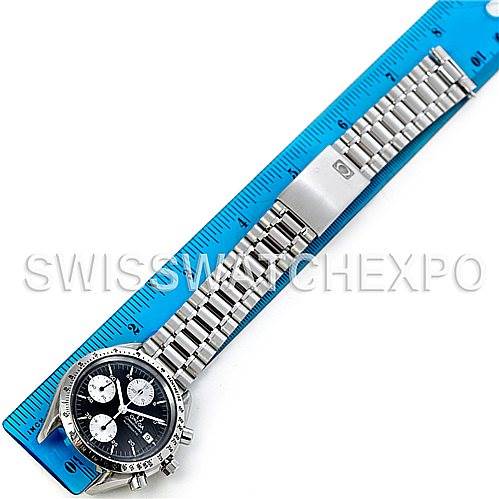 This image shows an Omega Speedmaster 3511.50.00 Men
s Stainless Steel Black Dial 3511.50.00 Men
s Stainless Steel Black Dial watch laid flat with its bracelet fully extended next to a blue ruler for size reference.