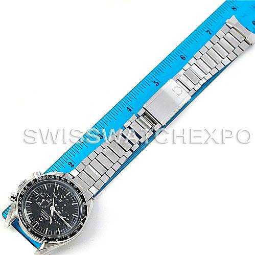 The image shows an overhead view of an Omega Speedmaster 145.022 Men's Stainless Steel Black Dial 145.022 Men's Stainless Steel Black Dial watch with its stainless steel bracelet fully extended, measured against a blue ruler.