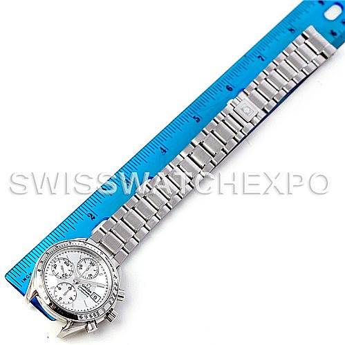 The Omega Speedmaster 3513.30.00 Men
s Stainless Steel Silver Dial 3513.30.00 Men
s Stainless Steel Silver Dial watch is shown from a top-down angle, displaying its face and metal bracelet next to a blue ruler for scale.