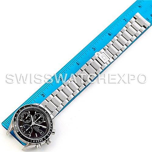 The Omega Speedmaster 3513.50.00 Men's Stainless Steel Black Dial 3513.50.00 Men's Stainless Steel Black Dial watch is shown from a top-down angle, displaying its face, strap, and clasp placed along a ruler.