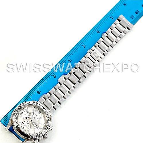 The image shows an Omega Speedmaster 3513.30.00 Men
s Stainless Steel Silver Dial 3513.30.00 Men
s Stainless Steel Silver Dial watch placed next to a blue ruler, highlighting the watch
s bracelet and dial from a top-down angle.
