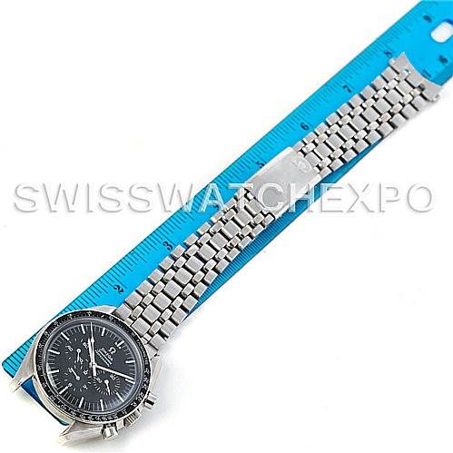 The Omega Speedmaster 145.022 Men
s Stainless Steel Black Dial 145.022 Men
s Stainless Steel Black Dial watch is shown flat with its face and metal bracelet fully visible, next to a blue ruler for scale.