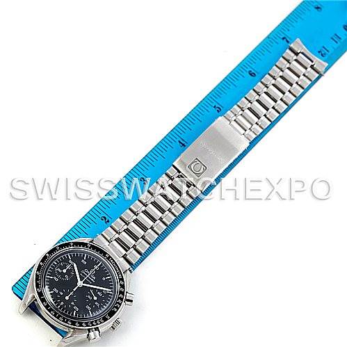 The image shows an Omega Speedmaster 3510.50.00 Men
s Stainless Steel Black Dial 3510.50.00 Men
s Stainless Steel Black Dial watch laid flat with its stainless steel band extended alongside a blue ruler.