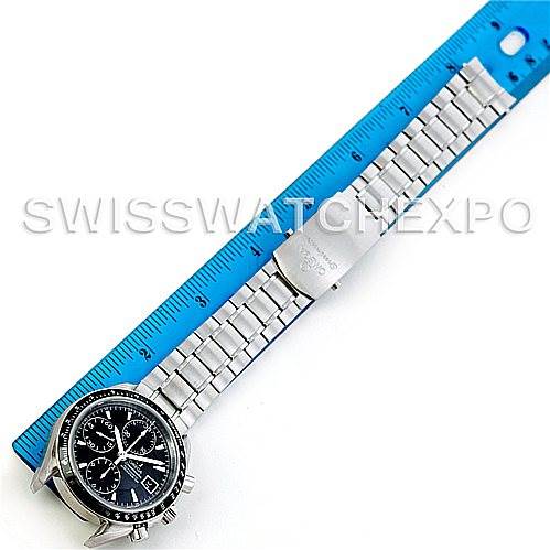 This image shows the Omega Speedmaster 3210.50.00 Men
s Stainless Steel Black Dial 3210.50.00 Men
s Stainless Steel Black Dial watch laid flat against a blue ruler, displaying its face and full metal bracelet.