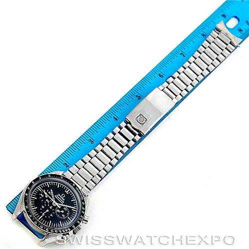 This image shows an Omega Speedmaster 145.022 Men
s Stainless Steel Black Dial 145.022 Men
s Stainless Steel Black Dial watch laid flat next to a ruler, displaying its full length and metal bracelet.