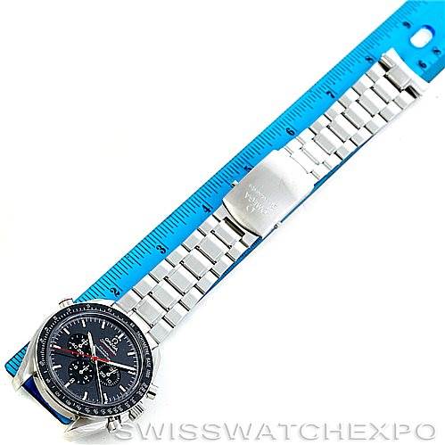 The image shows an Omega Speedmaster 311.30.44.51.01.001 Men
s Stainless Steel Black Dial 311.30.44.51.01.001 Men
s Stainless Steel Black Dial watch, visible from the face to the clasp, laid flat beside a blue ruler for measurement.