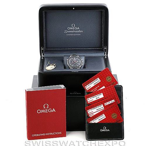 The image shows an Omega Speedmaster 311.30.44.51.01.001 Men
s Stainless Steel Black Dial 311.30.44.51.01.001 Men
s Stainless Steel Black Dial watch with its box, operating instructions, and warranty cards displayed frontally.