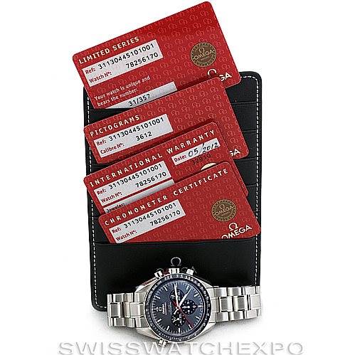 The image shows an Omega Speedmaster 311.30.44.51.01.001 Men
s Stainless Steel Black Dial 311.30.44.51.01.001 Men
s Stainless Steel Black Dial watch with its red warranty cards and black cardholder from a front angle.