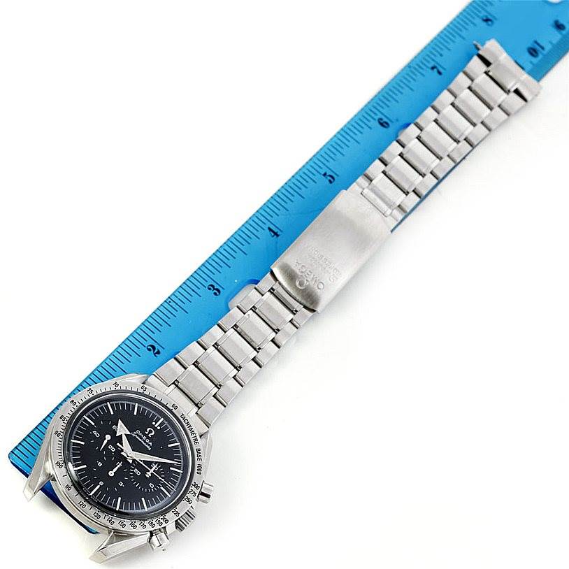 The image shows an Omega Speedmaster 3594.50.00 Men
s Stainless Steel Black Dial 3594.50.00 Men
s Stainless Steel Black Dial watch flat, featuring the face, bezel, and linked metal bracelet with a clasp next to a ruler.