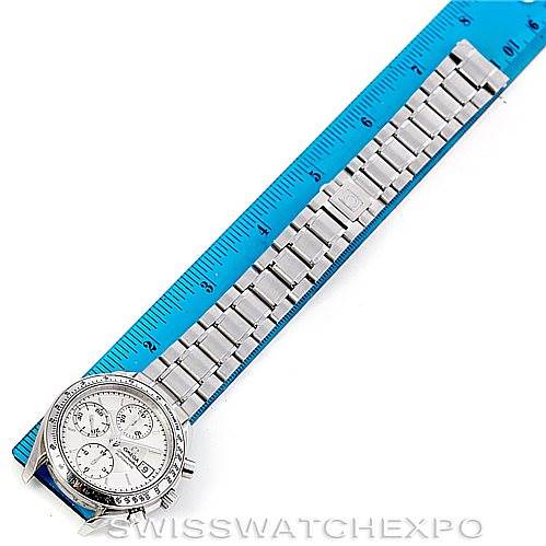 The image shows an Omega Speedmaster 3513.30.00 Men
s Stainless Steel Silver Dial 3513.30.00 Men
s Stainless Steel Silver Dial watch laid flat against a ruler, highlighting the watch face and metal bracelet.