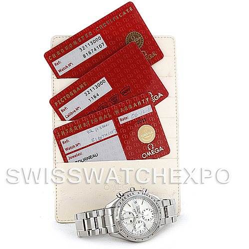 The image shows an Omega Speedmaster 3211.30.00 Men
s Stainless Steel Silver Dial 3211.30.00 Men
s Stainless Steel Silver Dial watch laying flat with three red certification cards on a white holder above it.