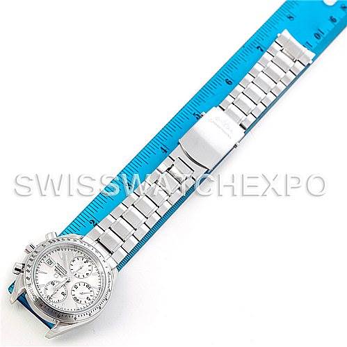 The image shows a top-down view of the Omega Speedmaster 3211.30.00 Men
s Stainless Steel Silver Dial 3211.30.00 Men
s Stainless Steel Silver Dial watch with a metal bracelet alongside a ruler.