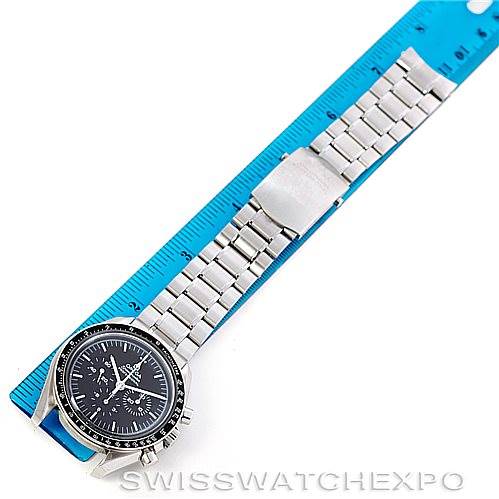 The image shows an Omega Speedmaster 3570.50.00 Men's Stainless Steel Black Dial 3570.50.00 Men's Stainless Steel Black Dial watch laid flat at a slightly oblique angle, including the face, strap, and clasp on top of a measuring tape.