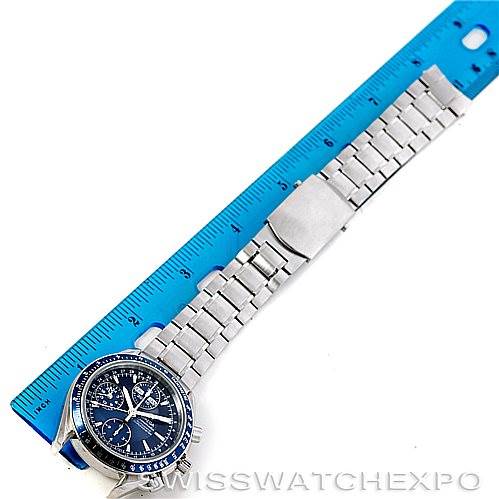 The image shows an Omega Speedmaster 3222.80.00 Men
s Stainless Steel Blue Dial 3222.80.00 Men
s Stainless Steel Blue Dial watch at an angled top view with a blue face and a metal bracelet next to a ruler for scale.