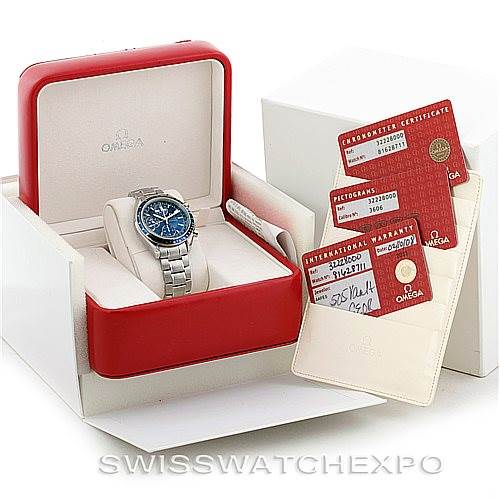 The image shows an Omega Speedmaster 3222.80.00 Men
s Stainless Steel Blue Dial 3222.80.00 Men
s Stainless Steel Blue Dial watch inside its open red box, along with warranty and chronometer certification cards.