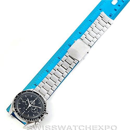 The Omega Speedmaster 3573.50.00 Men
s Stainless Steel Black Dial 3573.50.00 Men
s Stainless Steel Black Dial watch is shown from a top view, displaying the face, bezel, and entire metal bracelet alongside a blue ruler for scale.