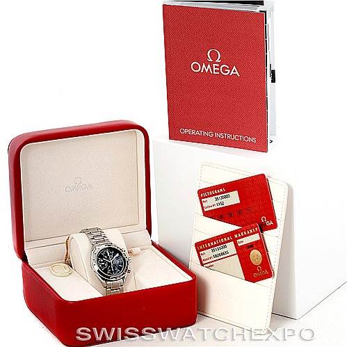 The image shows a Speedmaster model by Omega, including the watch, its red case, operating instructions, and warranty cards.