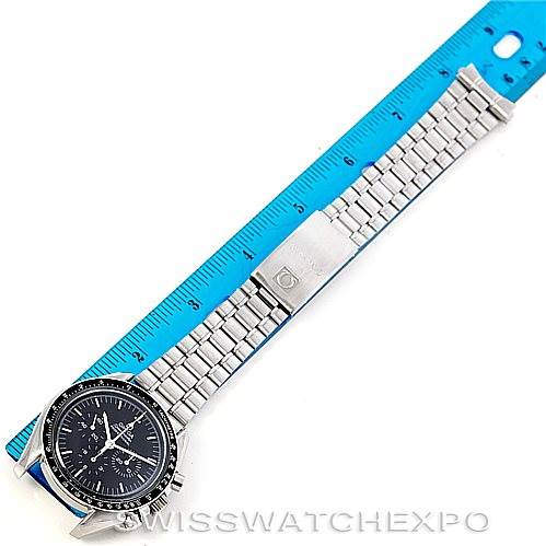 The image shows an Omega Speedmaster 3590.50.00 Men
s Stainless Steel Black Dial 3590.50.00 Men
s Stainless Steel Black Dial watch with a stainless steel bracelet next to a blue ruler for scale, viewed from above.