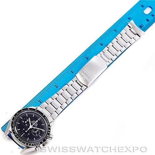 The image shows an Omega Speedmaster 3572.50.00 Men
s Stainless Steel Black Dial 3572.50.00 Men
s Stainless Steel Black Dial watch laid flat next to a blue ruler, displaying the full bracelet and face from an overhead angle.