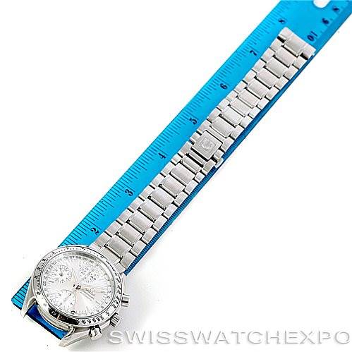 The Omega Speedmaster 3523.30.00 Men
s Stainless Steel Silver Dial 3523.30.00 Men
s Stainless Steel Silver Dial watch is displayed from a top-down angle alongside a blue ruler for scale.