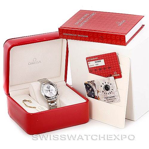 The image shows an Omega Speedmaster 3523.30.00 Men
s Stainless Steel Silver Dial 3523.30.00 Men
s Stainless Steel Silver Dial watch still in its open case, along with the warranty card and a manual.