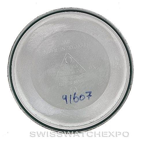 This image shows the inner case back of an Omega Speedmaster 3523.80.00 Men
s Stainless Steel Blue Dial 3523.80.00 Men
s Stainless Steel Blue Dial watch, featuring stamped branding and model information.