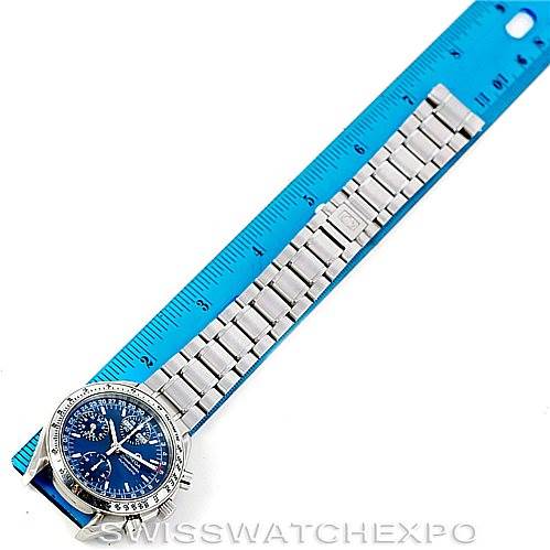 This image shows the face and bracelet of an Omega Speedmaster 3523.80.00 Men
s Stainless Steel Blue Dial 3523.80.00 Men
s Stainless Steel Blue Dial watch, measured against a blue ruler.