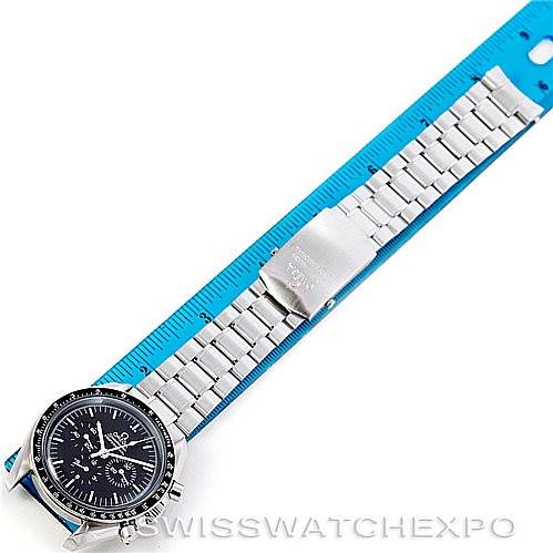 The image shows an Omega Speedmaster 3570.50.00 Men
s Stainless Steel Black Dial 3570.50.00 Men
s Stainless Steel Black Dial watch from a top-down angle, displaying the entire watch face, bracelet, and clasp aligned with a blue ruler.