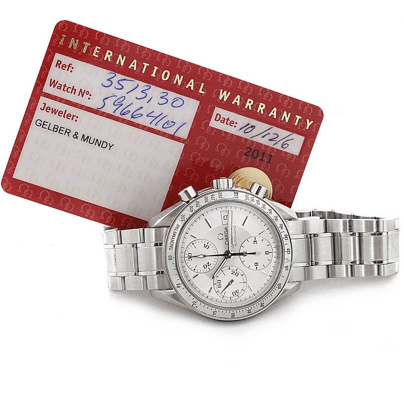 The image shows an Omega Speedmaster 3513.30.00 Men
s Stainless Steel Silver Dial 3513.30.00 Men
s Stainless Steel Silver Dial watch with its full bracelet and an international warranty card in the background.