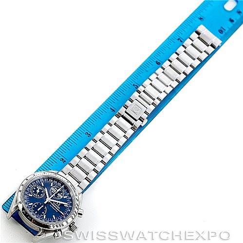 The image shows an Omega Speedmaster 3523.80.00 Men's Stainless Steel Blue Dial 3523.80.00 Men's Stainless Steel Blue Dial watch laid flat next to a blue ruler, displaying the watch face and metal bracelet.